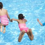 North Palm Beach family swimming in the community pool