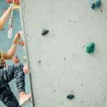 Young fit woman climbing an indoor rock wall