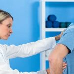 chiropractor examining a patient's thoracic spine