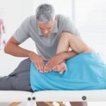 chiropractor adjusting patients tailbone