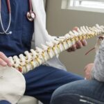 a chiropractor explaining the difference between chiropractic and orthopedic