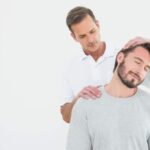 chiropractor adjusting the neck of patient