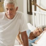 Man waking with back pain after sleeping improperly
