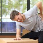 Young male worker experiencing occupational pain