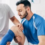 sports chiropractor helping patient