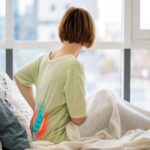 Redhead caucasian woman sitting upright in bed