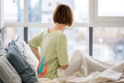 Redhead caucasian woman sitting upright in bed