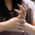 Woman stretching her wrist backward.