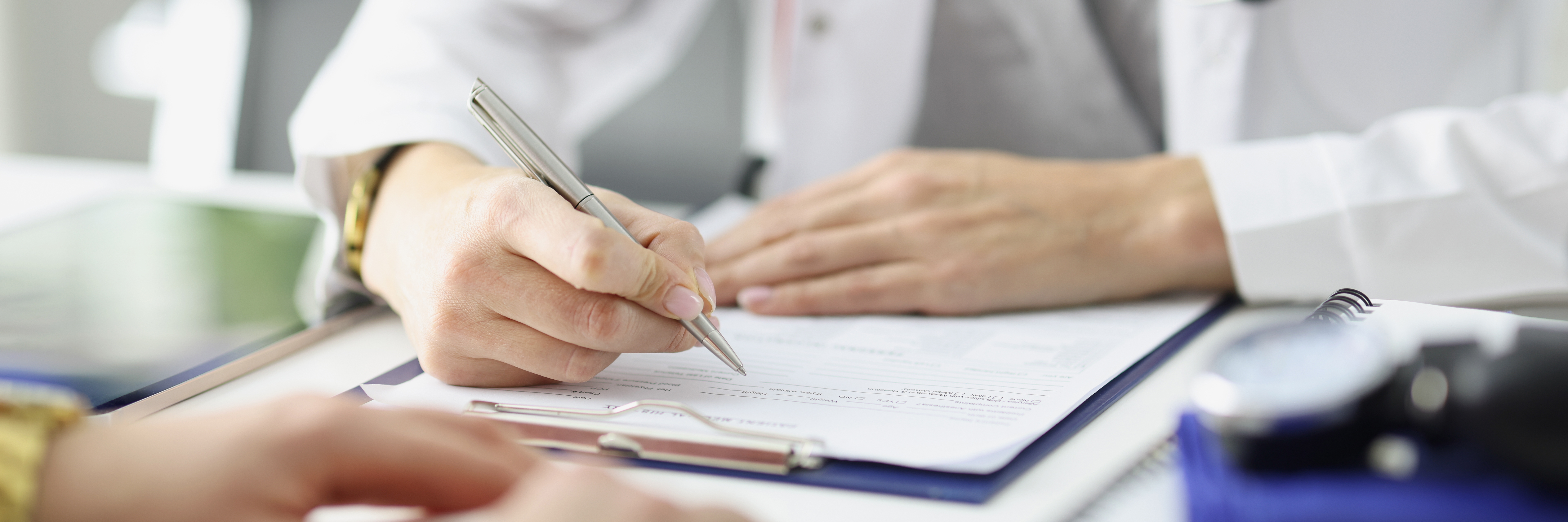 Medical expert writing information into documents.