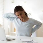 Woman with back pain caused by bad posture.