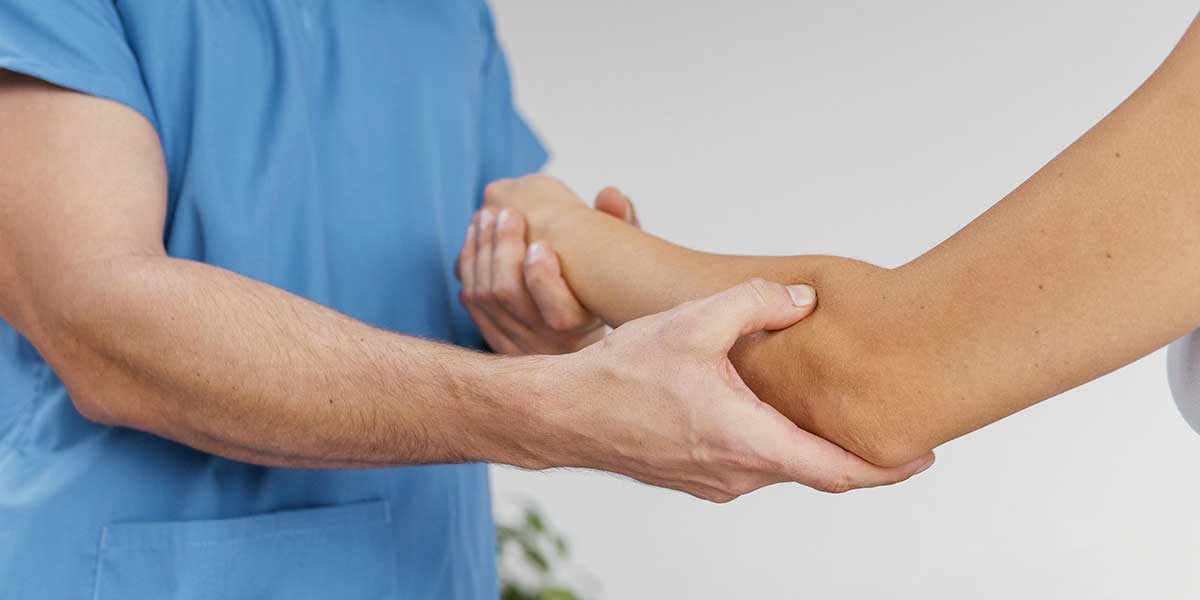 A chiropractor provides advanced chiropractic care for nerve pain treatment to a patient's arm in Boca Raton, FL.