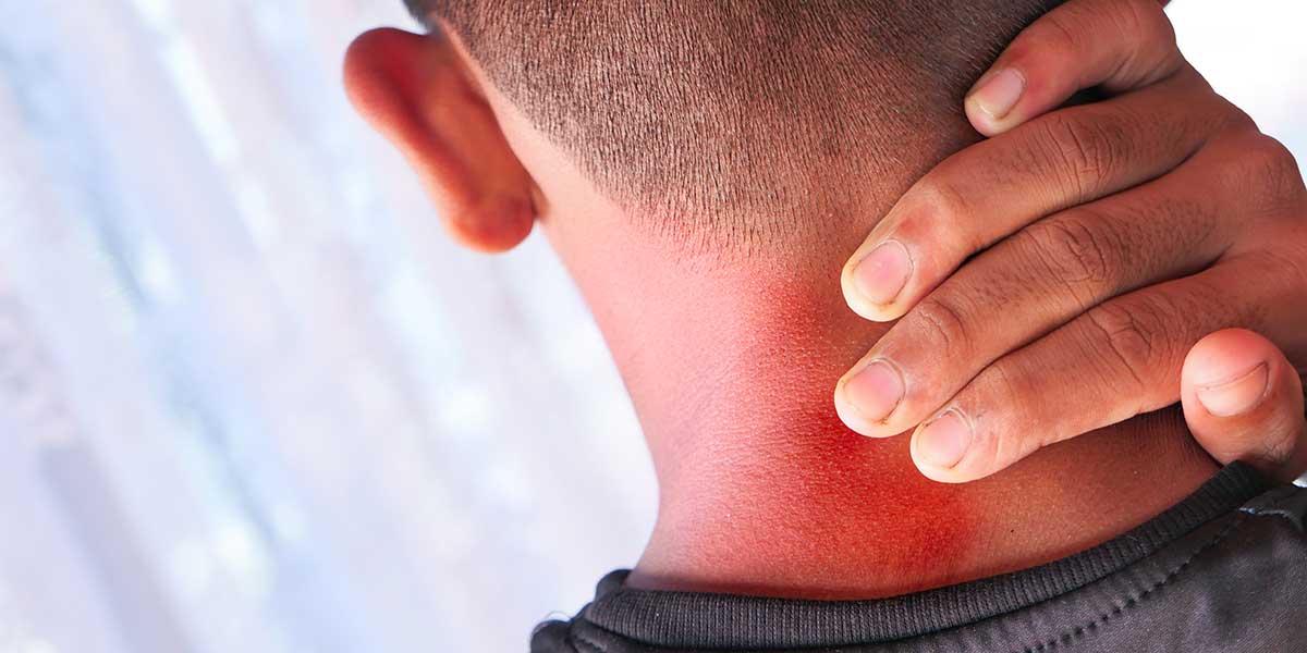 Close-up from behind of a man holding his neck, featuring a highlighted red area indicating severe pain and inflammation.